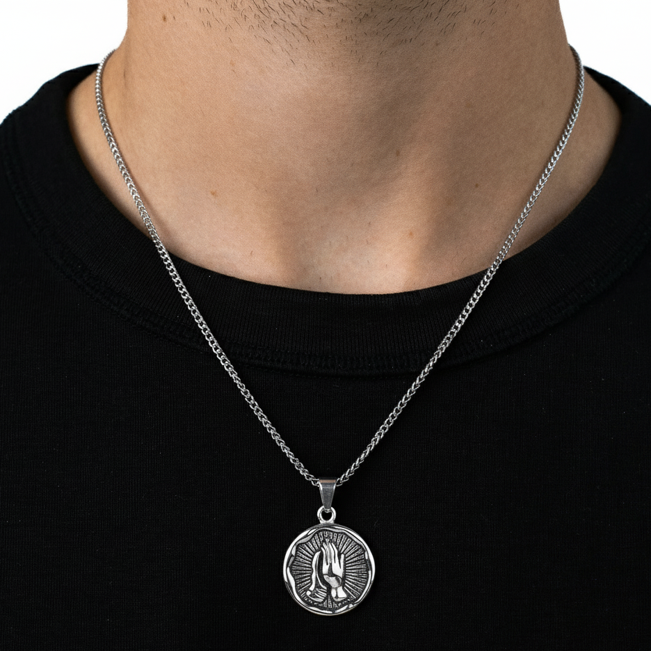 Silver necklace with a pendant on a black background