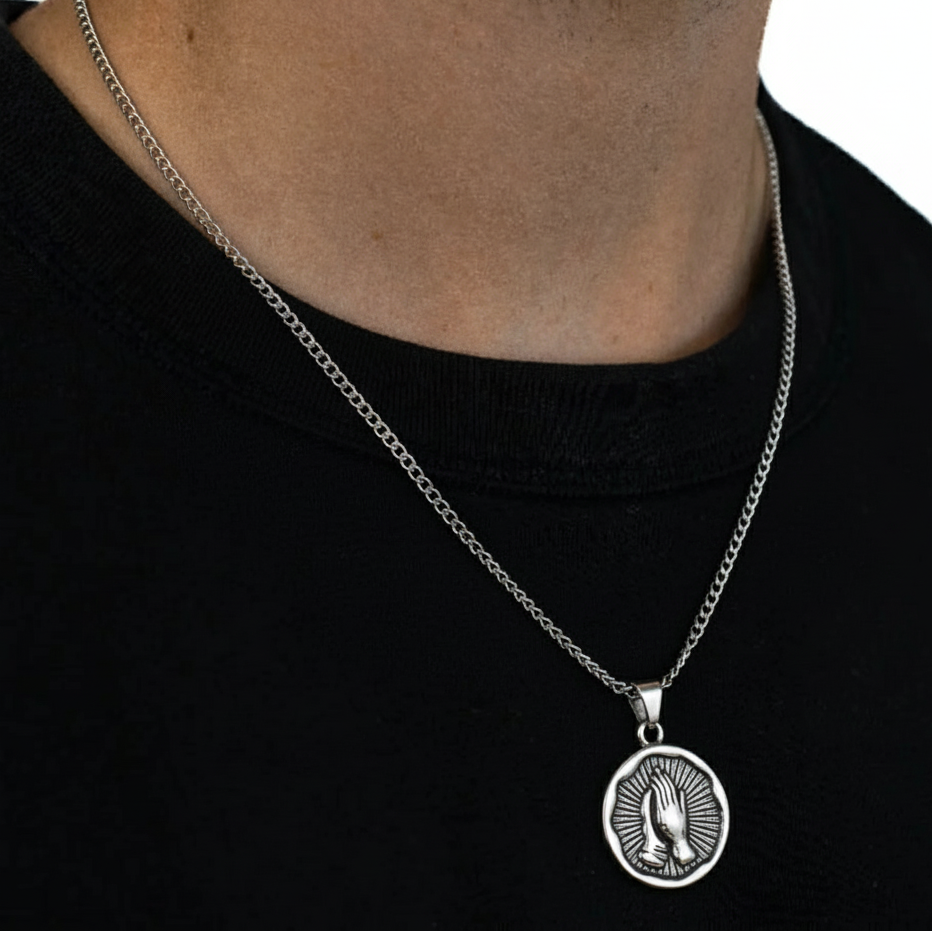 Silver necklace with a pendant on a black background