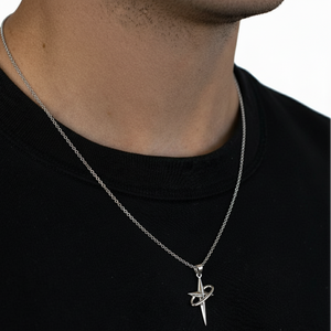 Silver necklace with a star pendant on a black shirt