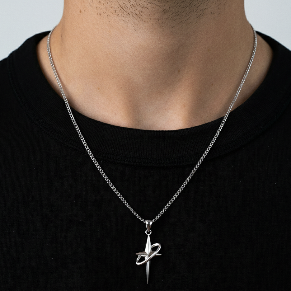 Silver necklace with a unique pendant on a person wearing a black shirt.